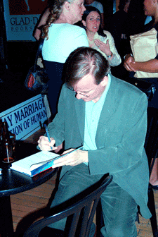 Kevin Bourass signing a copy of Just Married.  (Photo by Ken Tong, 2002)